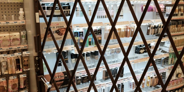 A gate is used to lock items at a pharmacy and convenience store on Oct. 26, 2021, in New York City.
