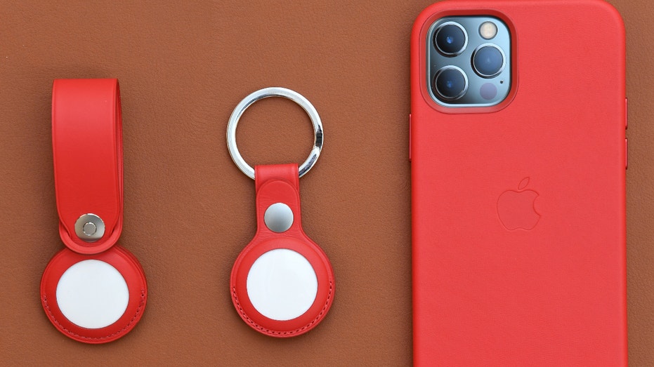 APRIL 30: Loop and key ring accessories for the new AirTags next to an iPhone 12 on display at the Apple Store George Street on April 30, 2021 in Sydney, Australia. Apple's latest accessory, the AirTag is a small device that helps people keep track of belongings, using Apple's Find My network to locate lost items like keys, wallet, or a bag. (Photo by James D. Morgan/Getty Images)