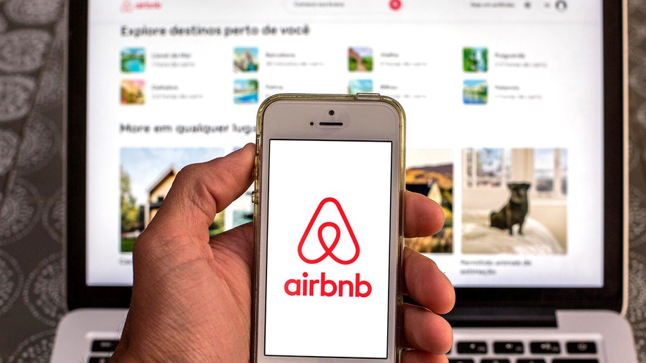 SPAIN - 2021/04/15: In this photo illustration, the Airbnb app seen displayed on a smartphone screen with the Airbnb website displayed on a laptop in the background. (Photo Illustration by Thiago Prudencio/SOPA Images/LightRocket via Getty Images)