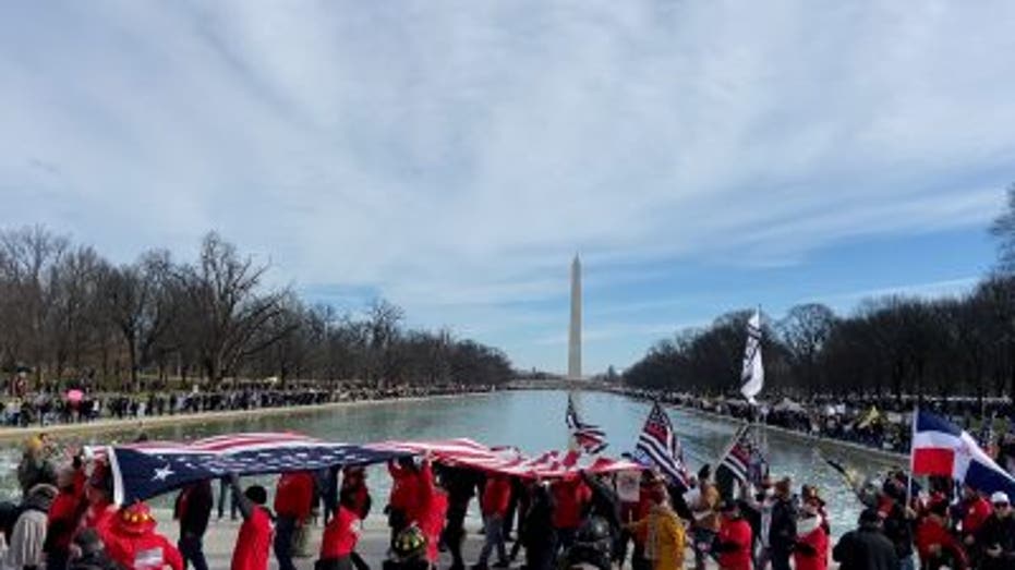 "Defeat the Mandates" rally attendees marching towards the Lincoln Memorial