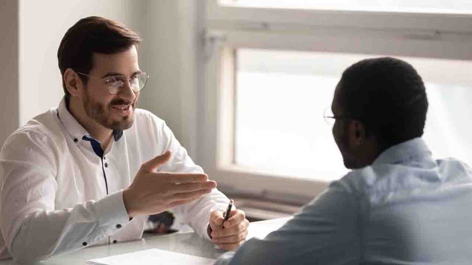 Two men talk during interview