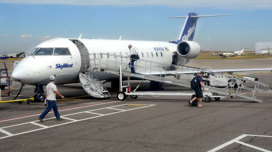 Passengers board a SkyWest Airlines Bombardier CRJ-100 passenger plane at Denver International Airport on Sept. 7, 2016. 