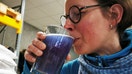 Hoppy Urban Brew (HUB) worker Mathilde Vanmansart drinks a glass of the Line blue beer, which is made with spirulina algae, during an interview with Reuters inside the brewery in Roubaix near Lille, France, January 31, 2022. REUTERS/Ardee Napolitano