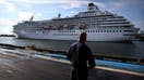 Boston, MA - August 18: A pedestrian watches as the Crystal Symphony cruise ship arrives at Flynn Cruiseport in Boston, MA on August 18, 2021. The ship is scheduled to depart Sunday for a weeklong trip to Bermuda. (Photo by Craig F. Walker/The Boston Globe via Getty Images)