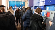 Russians wait in long lines to withdraw from ATMs as crippling sanctions take effect