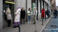 Ukraine bank customers seen withdrawing cash from ATMs