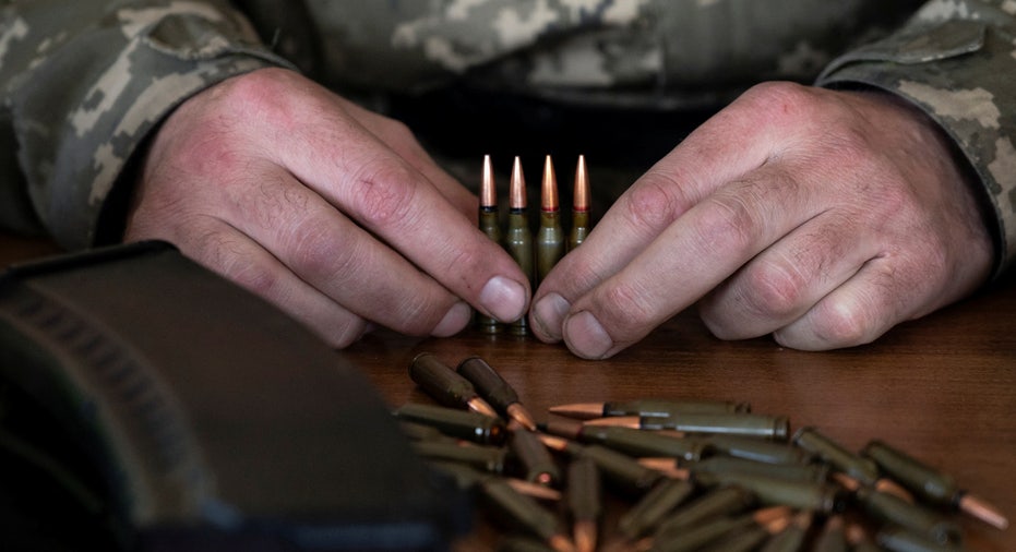A Ukrainian service member loads ammunition into cartridges in Zhytomyr