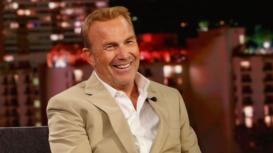 Kevin Costner sports khaki suit and white shirt on talk show
