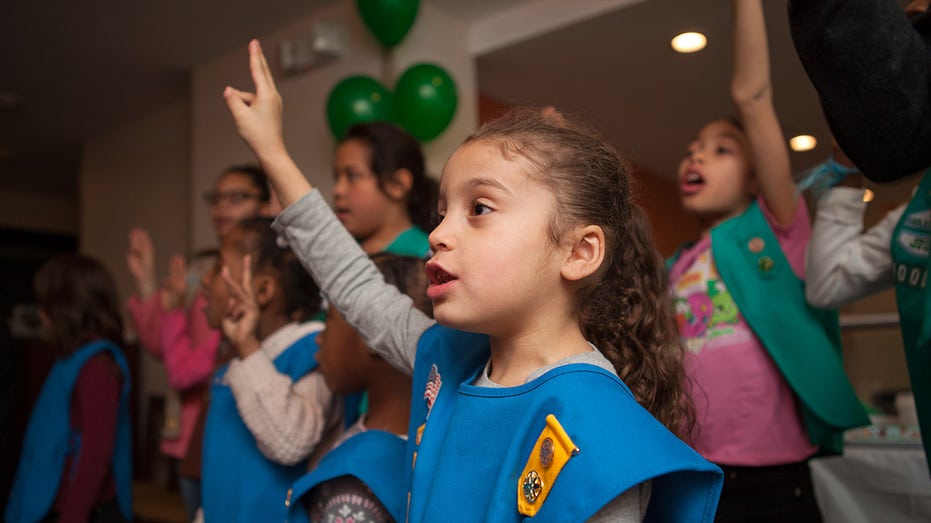 Girl Scout raising hand