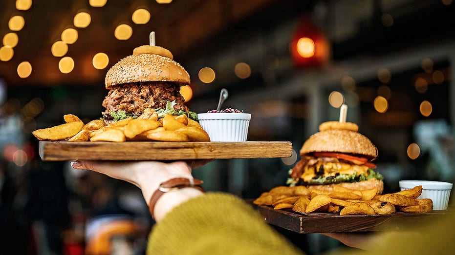 Woman carrying burger