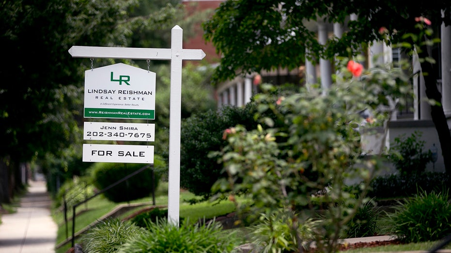 A sign sits outside a home for sale in the 16th Street Heights neighborhood of Washington, D.C. 