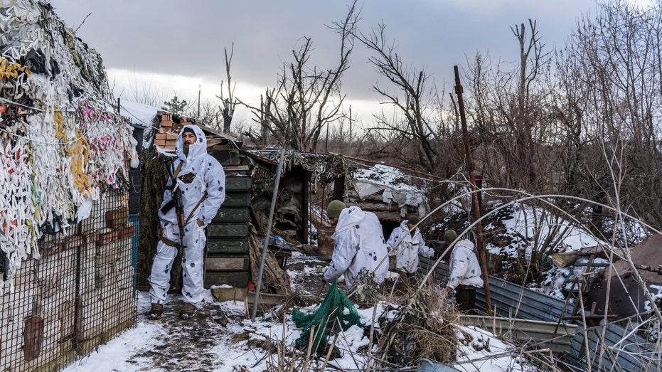 Anatoliy (L) and other Ukrainian soldiers with the 56th Brigade in a trench on the front line on Jan. 18, 2022, in Pisky, Ukraine. 