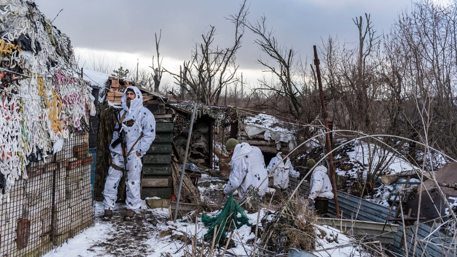 Anatoliy (L) and other Ukrainian soldiers with the 56th Brigade in a trench on the front line on Jan. 18, 2022, in Pisky, Ukraine.