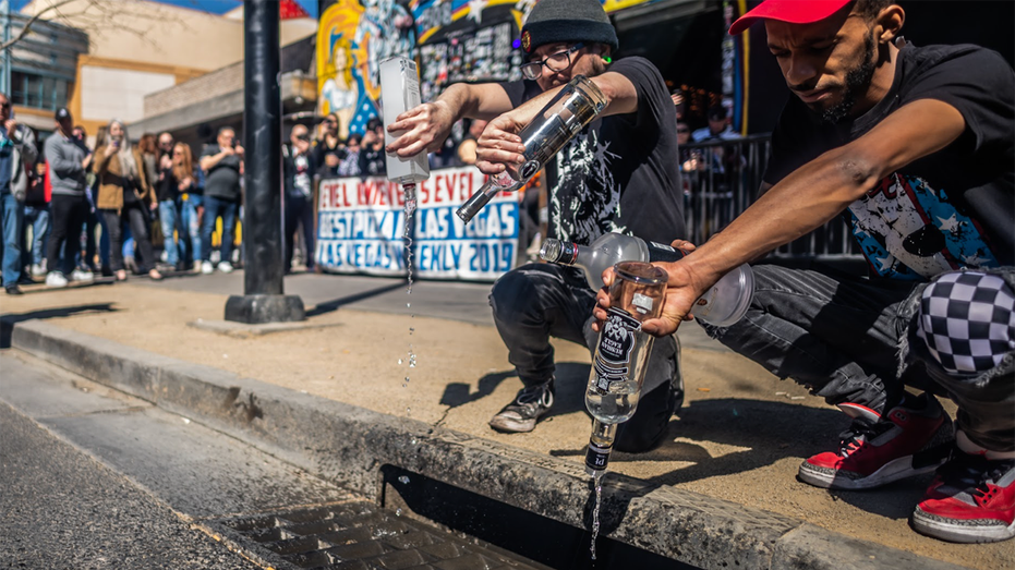 Bartenders from Evel Pie pour Russian vodka down the drain in downtown Las Vegas.