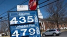 A car passes a gas station sign in Annapolis, Maryland, on March 14, 2022, as record high gas prices hit working-class Americans with inflation already surging. (Photo by Jim WATSON / AFP) (Photo by JIM WATSON/AFP via Getty Images)
