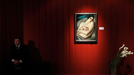 FILE PHOTO: A security guard sits next to a Tamara de Lempicka painting at Sotheby's preview of upcoming major Russian art auctions in New York and London, at the Russian Academy of Arts in Moscow October 19, 2011. REUTERS/Denis Sinyakov/File Photo
