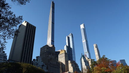 NEW YORK, NY - NOVEMBER 9: The Steinway Tower and Central Park Tower on Billionaires' Row rise above fall foliage in Central Park on November 9, 2021, in New York City. 