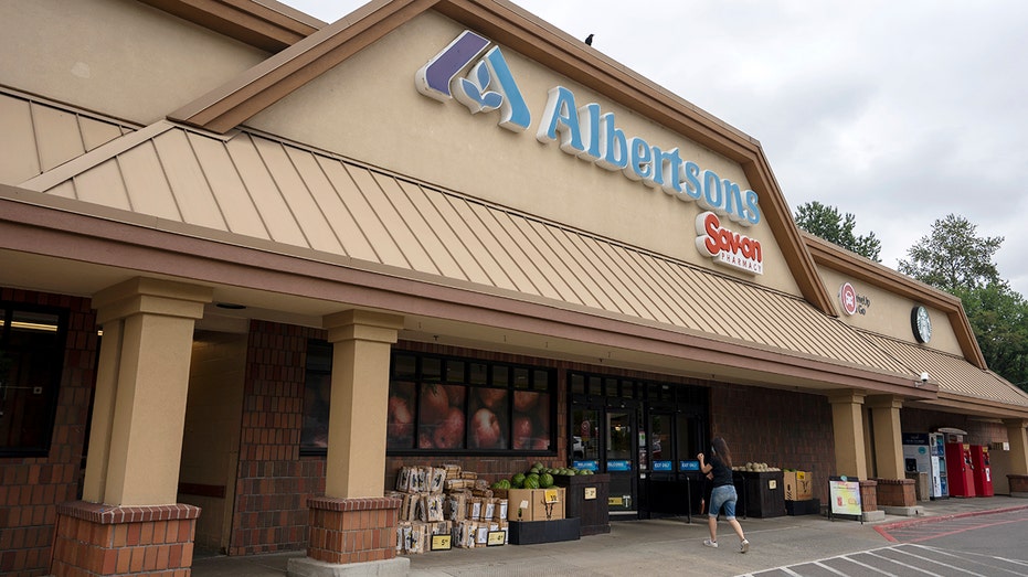 A shopper enters an Albertsons grocery store and its Sav-on pharmacy in Portland, Oregon.