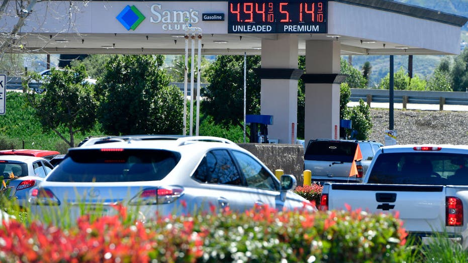 Cars and motorists stand in line at a Sam's Club gas station