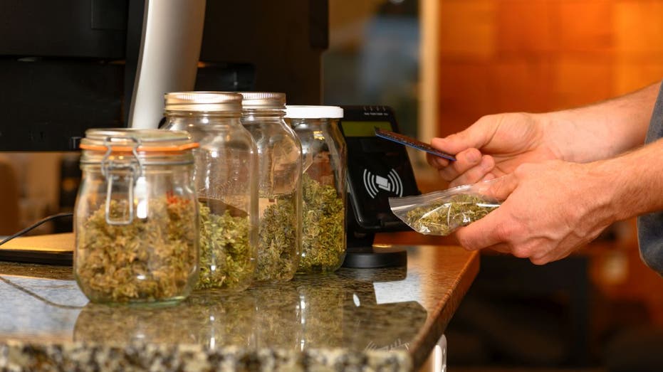 Person buying cannabis at dispensary