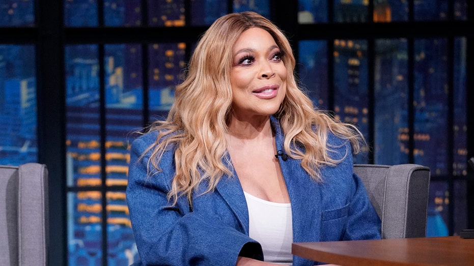 Talk show host Wendy Williams wears blue blazer with white blouse at Seth Meyers.