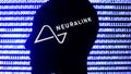 Neuralink logo displayed on a phone screen, a silhouette of a paper in shape of a human face and a binary code displayed on a screen are seen in this multiple exposure illustration photo taken in Krakow, Poland on December 10, 2021. - Fox News
