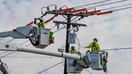 Utility company repairs electric lines