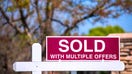 'SOLD With Multiple Offers' real estate sign near purchased house indicates hot seller's market in a desired neighborhood. - Fox Business News