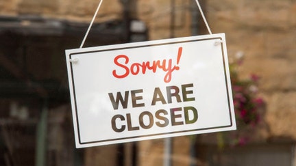 Sorry, we are closed sign in a shop window.