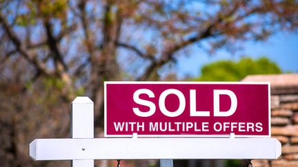 'SOLD With Multiple Offers' real estate sign near purchased house indicates hot seller's market in a desired neighborhood. - Fox Business News