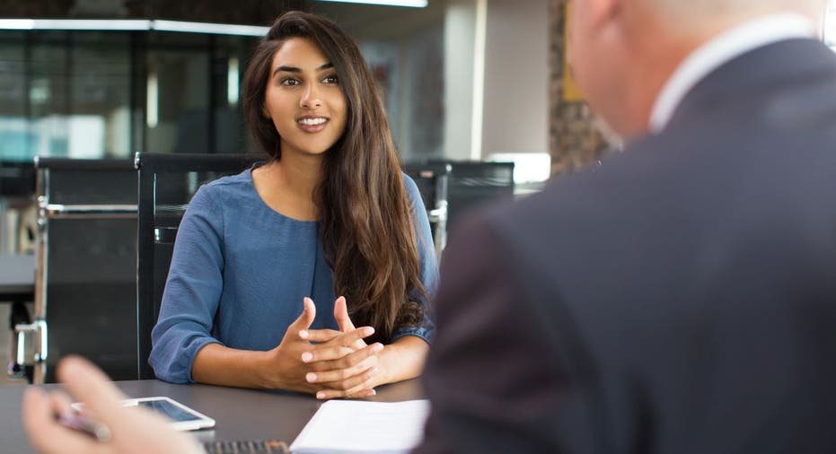 Woman speaks to man at interview desk