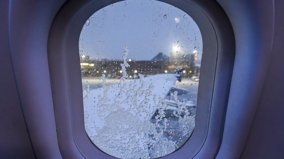 Snow on an airplane window
