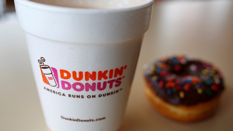 A Dunkin' Donuts coffee and donut with sprinkles