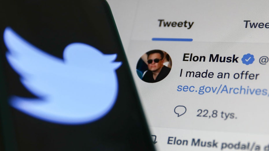 Elon Musk's Tweet displayed on a screen and Twitter logo