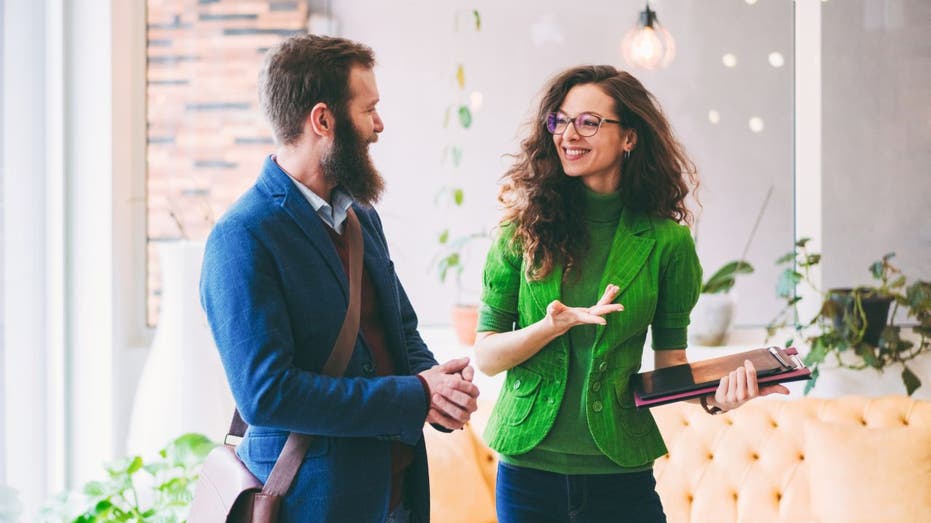 Worker talk while standing in office