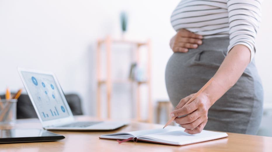 Pregnant worker standing