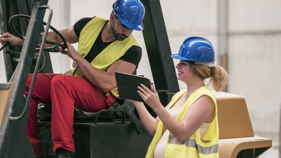 Pregnant worker in warehouse