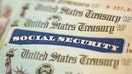 WASHINGTON, DC - OCTOBER 14: In this photo illustration, a Social Security card sits alongside checks from the U.S. Treasury on October 14, 2021 in Washington, DC. The Social Security Administration announced recipients will receive an annual cost of living adjustment of 5.9%, the largest increase since 1982. The larger increase is aimed at helping to offset rising inflation. (Photo illustration by Kevin Dietsch/Getty Images)