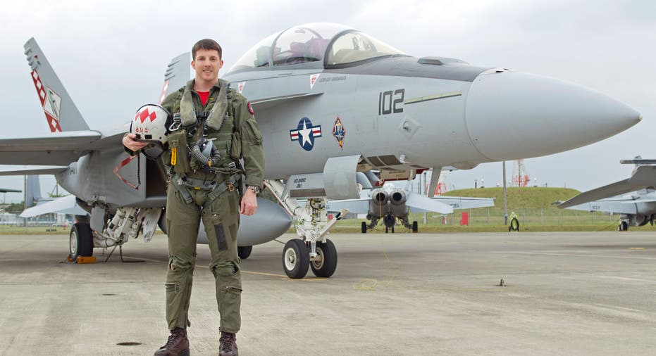 Former TOPGUN instructor Guy Snodgrass poses next to jet