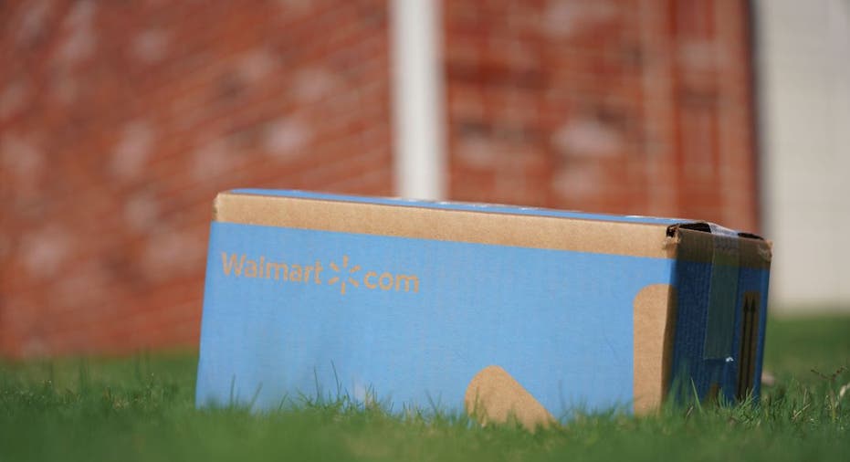 A Walmart package sits in a customer's yard after being delivered by drone