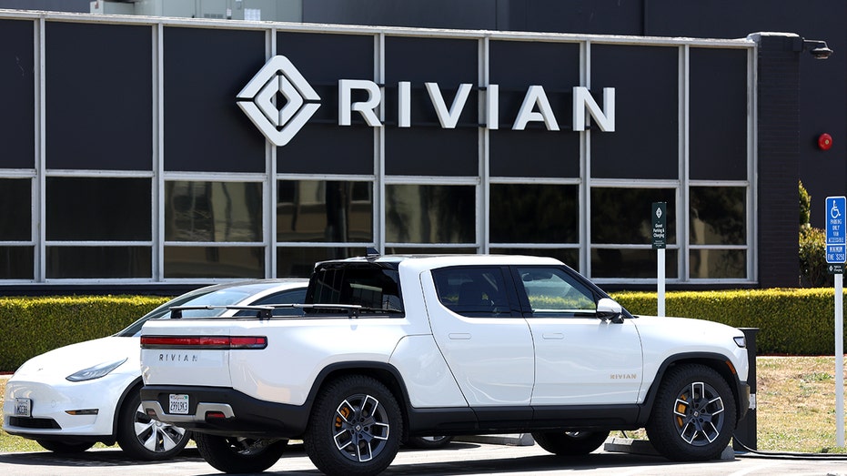 Rivian vehicles sit outside a showroom.