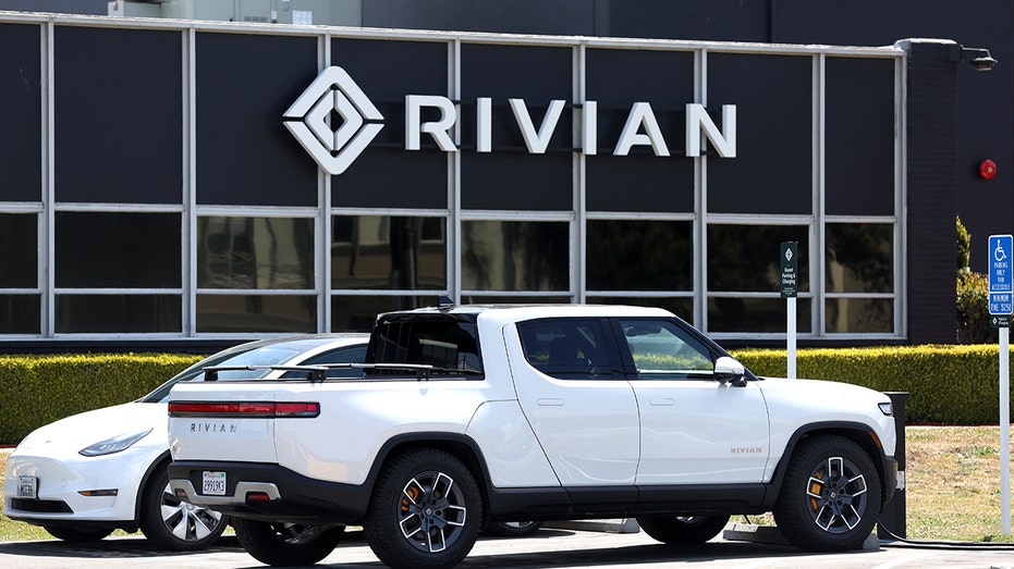 Rivian vehicles sit outside a showroom.