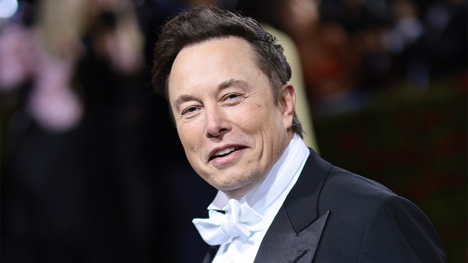 Elon Musk smiling in a tuxedo