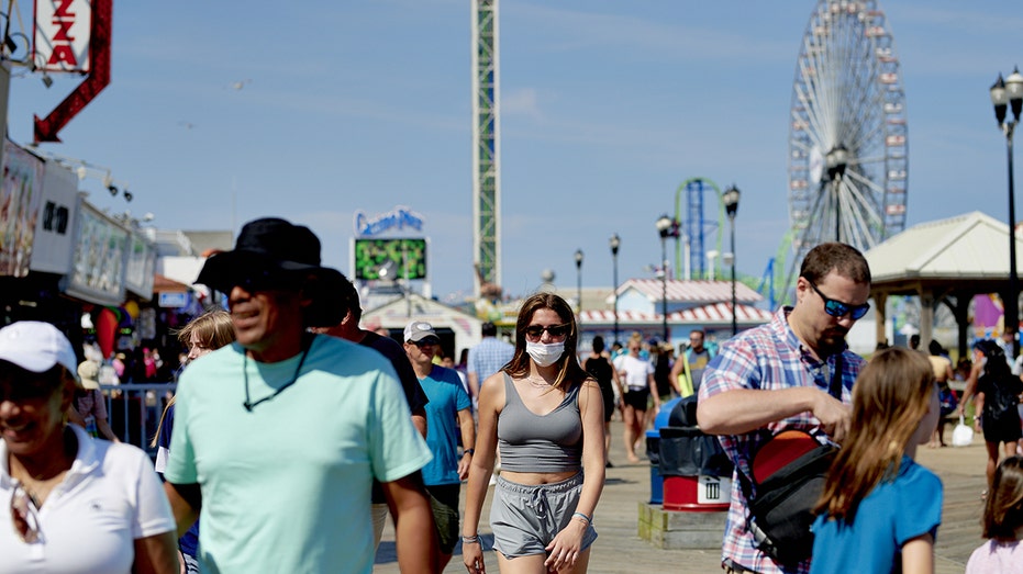 People walk along the Jersey Shore Boardwalk during the summer