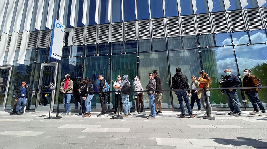 Customers wait in line outside the new Meta retail store on its opening day in Burlingame, California, May 9, 2022. REUTERS/Nathan Frandino