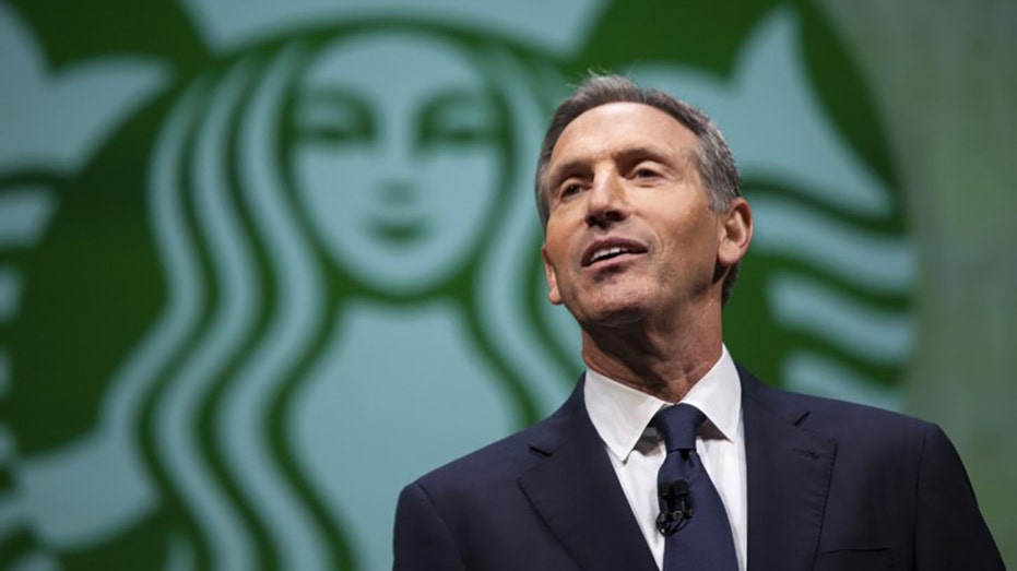 CEO of Starbucks Howard Schultz speaking in Seattle with green mermaid logo in the background