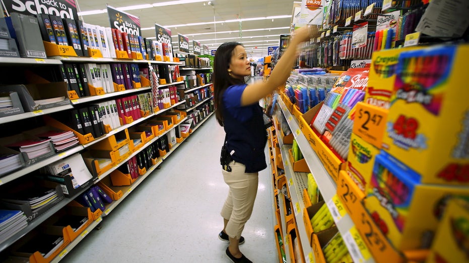 Walmart store manager stocking shelves