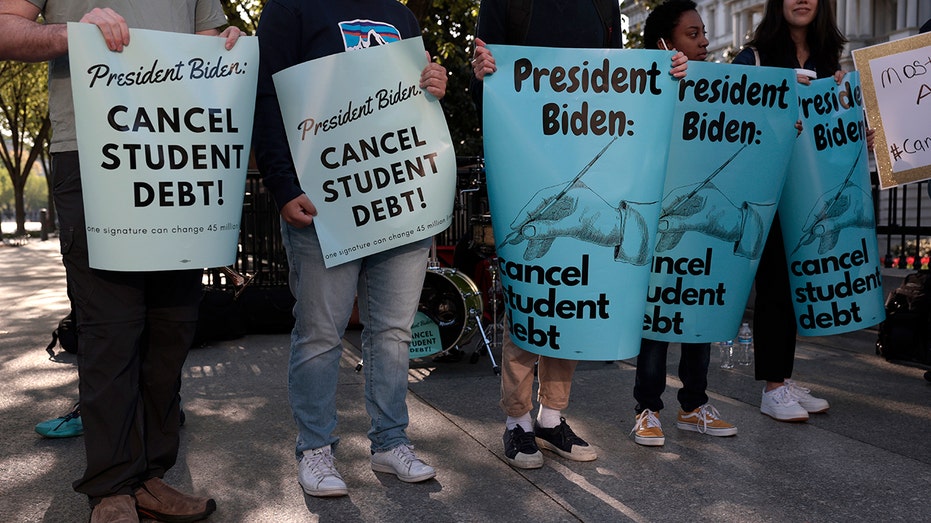 Student loan forgiveness protesters holding signs