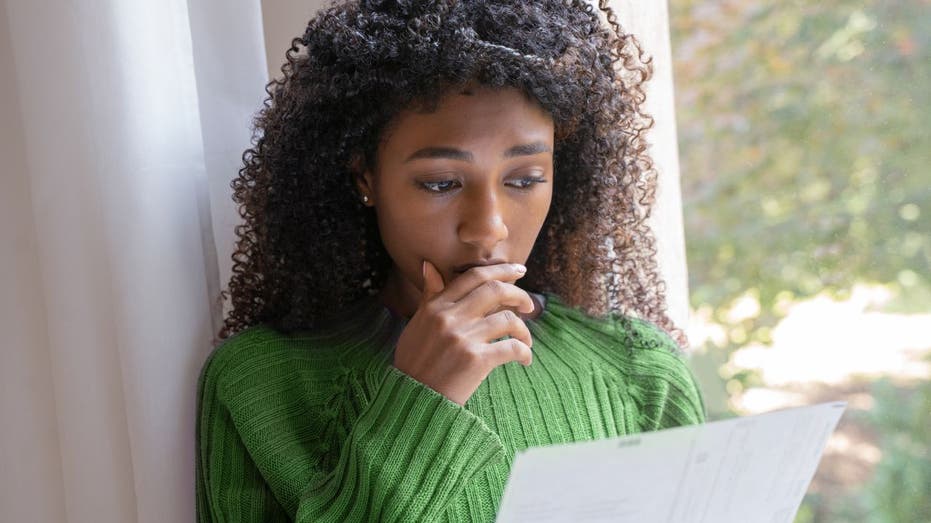 Woman reads rejection letter