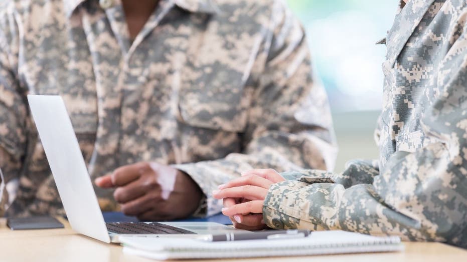 Two military officers have a discussion during a formal meeting